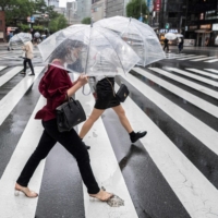 Pedestrians cross a street in Tokyo on Friday.  | AFP-JIJI