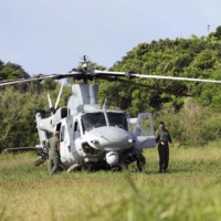 A U.S. military helicopter landed off-base Wednesday in a field on Tsuken Island, Okinawa Prefecture. | KYODO