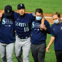 Mariners pitcher Yusei Kikuchi (second from left) is helped off the field after being hit by a ball during his start against the Angels on Saturday in Anaheim, California. | 
JUN 5, 2021; ANAHEIM, CALIFORNIA, USA; SEATTLE MARINERS STARTING PITCHER YUSEI KIKUCHI (18) IS HELPED OFF THE FIELD AFTER BEING HIT BY A BALL FROM LOS ANGELES ANGELS SECOND BASEMAN DAVID FLETCHER (22) DURING THE FIFTH INNING AT ANGEL STADIUM. MANDATORY CREDIT: GARY A. VASQUEZ-USA TODAY SPORTS