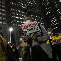 Demonstrators march during an anti-Olympic protest in Tokyo on June 23.  | BLOOMBERG