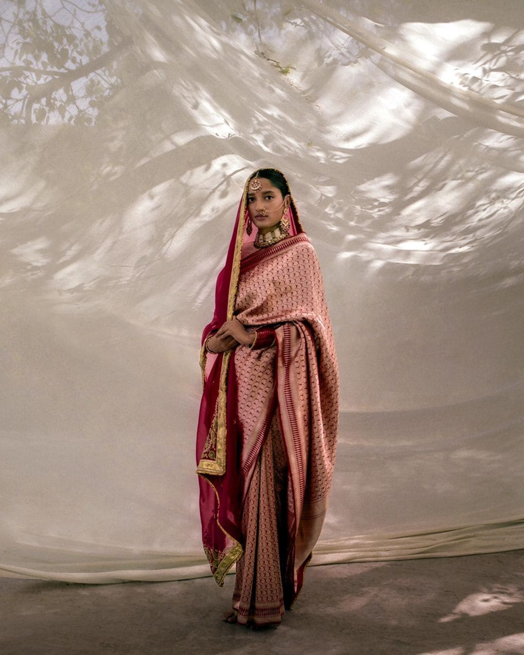 Model wearing a Varanasi silk brocade ‘Amvi’ sari with all-over jaal (lattice) of paisley motifs.