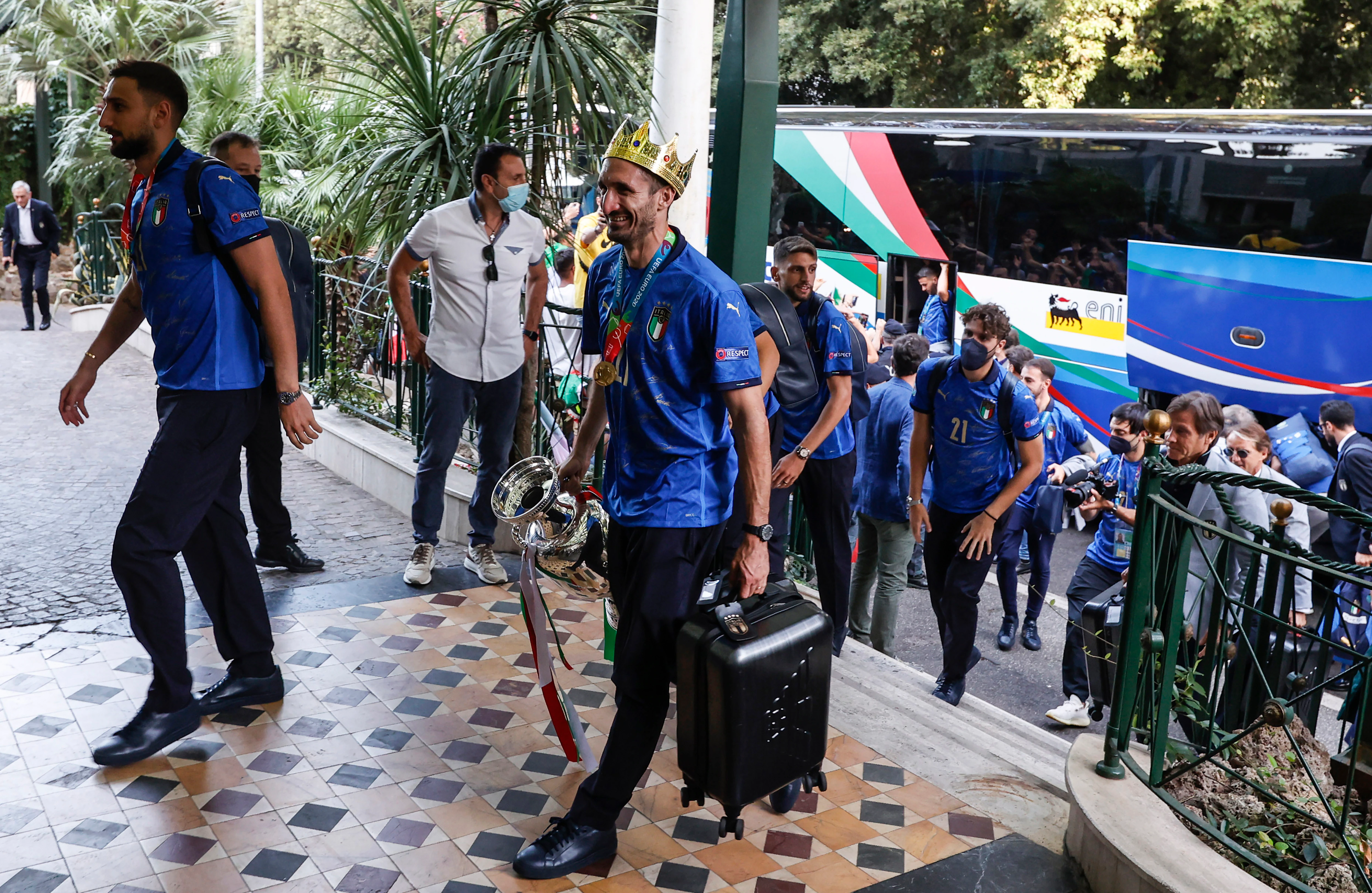 Euro 2020- Italy's captain Giorgio Chiellini, wearing a crown and holding the trophy, and his teammates arrive at a hotel after returning from London, in Rome.(AP)