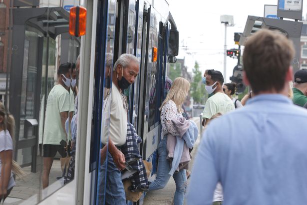 Commuters still wore face masks after restrictions were lifted but the Delta variant spread rapidly