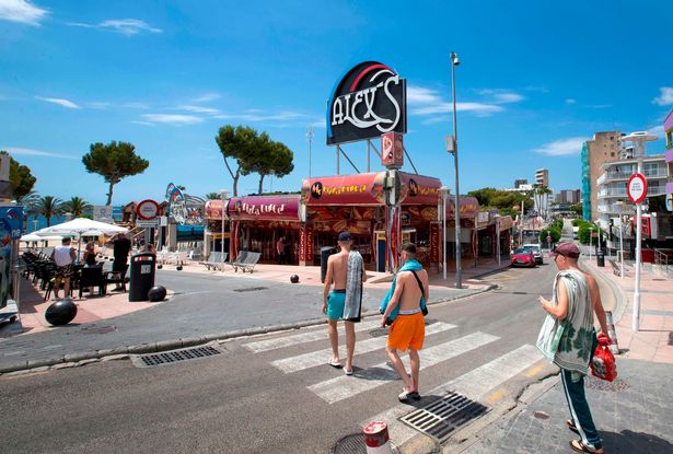 Tourists walk at Punta Ballena street in Magaluf, Calvia, in Spain's Balearic island of Majorca