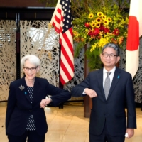 U.S. Deputy Secretary of State Wendy Sherman elbow bumps with Japanese Vice Foreign Minister Takeo Mori prior to their meeting at the Iikura Guesthouse in Tokyo on Tuesday. | POOL / VIA REUTERS