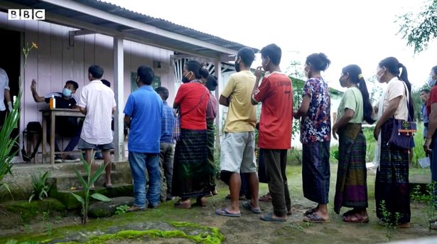 Latgum Singpu and his team carry the vaccines through the jungle