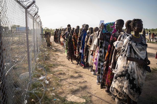 Women from Murle ethnic group wait in a line for a food distribution by United Nations World Food Programme (WFP) in Gumuruk, South Sudan