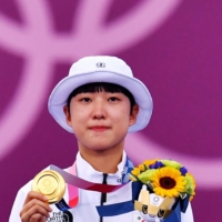 Gold medalist An San of South Korea celebrates on the podium.  | REUTERS