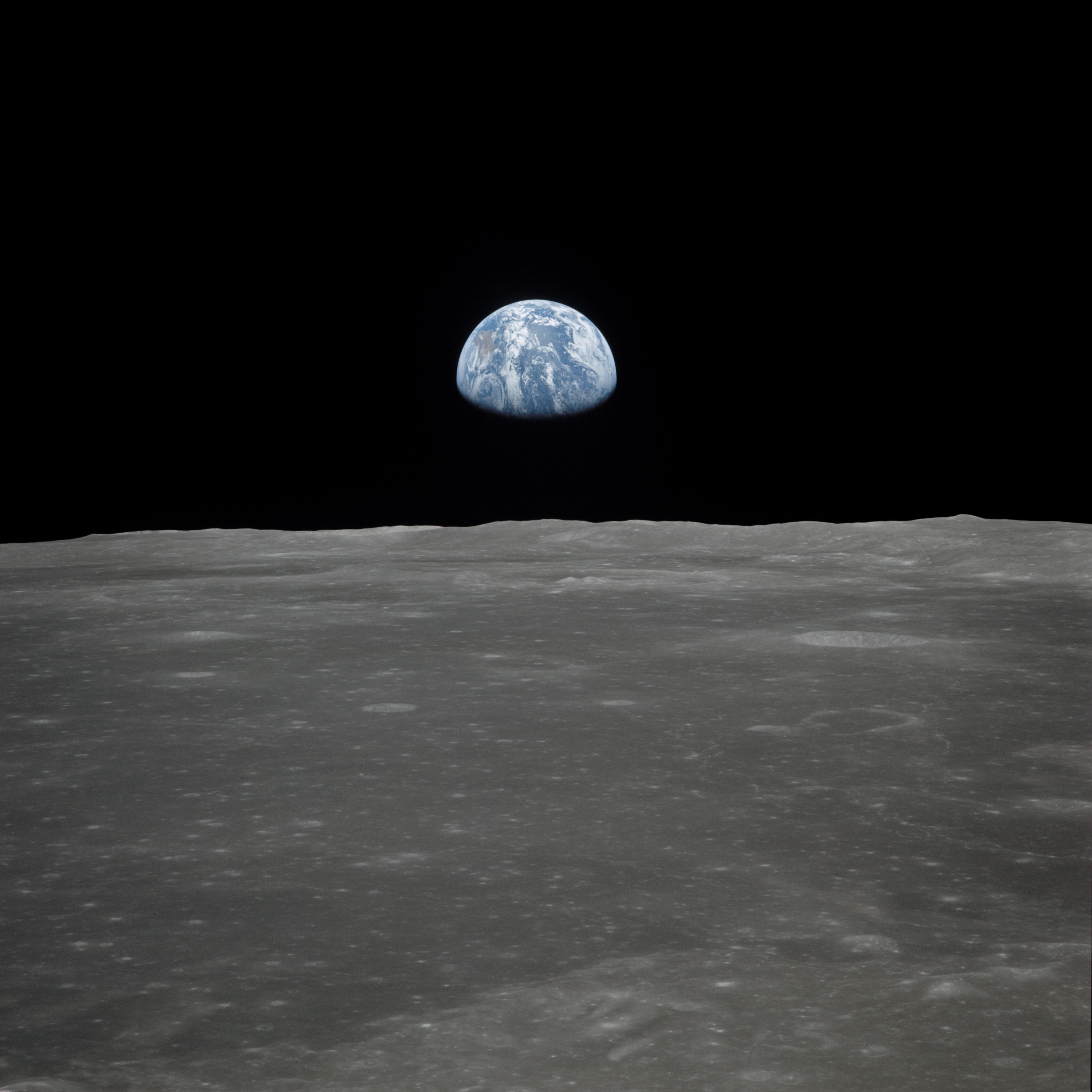 Earth rising over the Moon's horizon was taken from the Apollo 11 spacecraft. The lunar terrain pictured is in the area of Smyth's Sea on the nearside.(NASA)