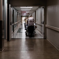 A COVID-19 patient is moved by gurney at a medical center in Mountain Home, Arkansas, on July 8. Under-vaccinated areas in the U.S. are bearing the brunt of rising infections and hospitalizations from the delta variant. | ERIN SCHAFF / THE NEW YORK TIMES