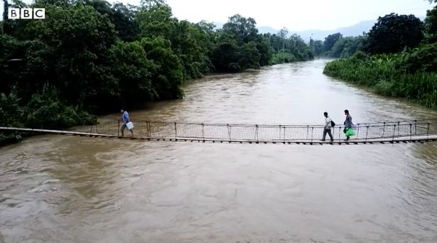 The health workers cross the river