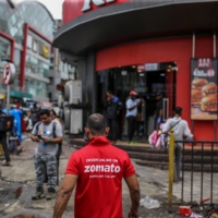 A Zomato Ltd. delivery rider walks toward a KFC restaurant in Mumbai, India, on Friday.  | BLOOMBERG