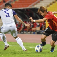 Grampus' Manabu Saito controls the ball during his club's Asian Champions League match against Ratchaburi FC on Thursday in Bangkok. | KYODO