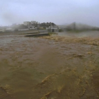 Water levels on the Kise River in Numazu, Shizuoka Prefecture, surged on Saturday after heavy rains hit the area. | NUMAZU OFFICE OF RIVERS AND NATIONAL HIGHWAYS / VIA KYODO