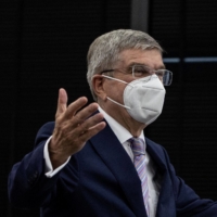 International Olympic Committee chief Thomas Bach gestures as he arrives at a meeting with Tokyo 2020 head Seiko Hashimoto in Tokyo on Tuesday. | POOL / VIA AFP-JIJI