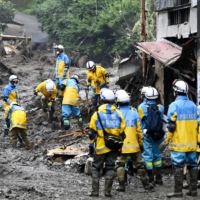 Police officers search for missing people in Atami, Shizuoka Prefecture, on Wednesday following a huge mudslide on July 3. | KYODO