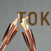 Torches during a torch kiss event, after a relay on a public road was canceled due to the coronavirus pandemic | REUTERS