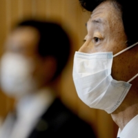 Economic revitalization minister Yasutoshi Nishimura speaks to reporters Thursday in Tokyo. | KYODO