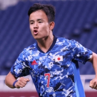 Japan's Takefusa Kubo celebrates after scoring his team's opening goal against Mexico on Sunday in Saitama. | AFP-JIJI