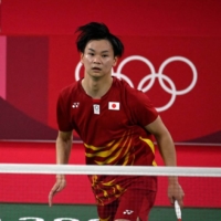 Japan's Arisa Higashino hits a shot next to partner Yuta Watanabe during their bronze medal match against Hong Kong's Tang Chun Man and Tse Ying Suet.  | AFP-JIJI