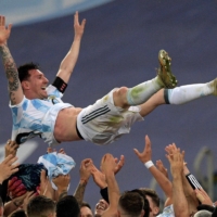 Lionel Messi is thrown into the air by his Argentina teammates after they won the 2021 Copa America final against Brazil on Saturday in Rio de Janeiro. | AFP-JIJI