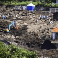 Workers continued to search for missing people in the mudslide-hit city of Atami, Shizuoka Prefecture, on Monday, more than two weeks after the disaster that killed at least 18 people. | KYODO