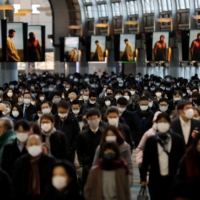 Commuters make their way through Shinagawa Station in Tokyo earlier this year.  | REUTERS