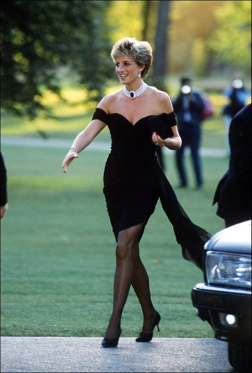 A black off-the-shoulder dress called the Revenge Dress by Christina Stambolian and a choker arriving at the Serpentine Gallery in London from 1994