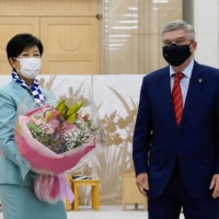 Thomas Bach (right), president of the International Olympic Committee, meets with  Tokyo Gov. Yuriko Koike in Tokyo on Thursday. |  BLOOMBERG