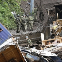 Self-Defense Forces personnel search for the missing in Atami, Shizuoka Prefecture, on Monday after Saturday's mudslides. | KYODO