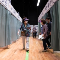 Elderly residents leave after receiving a dose of the Pfizer-BioNTech COVID-19 vaccine at a vaccination site inside the Guro Arts Valley Theater in the Guro district of Seoul on June 8. | BLOOMBERG