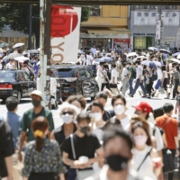 Pedestrians fill the pavements in the Shibuya district of Tokyo on Thursday. | KYODO