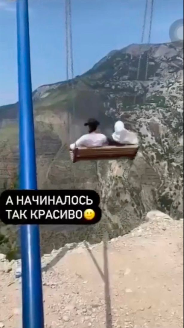 Two women having a go on a swing installed by the edge of Sulak canyon in Dagestan, Russia