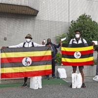 Members of the Ugandan Olympic team prepare to leave a hotel in Izumisano, Osaka Prefecture, on Tuesday to head for Tokyo for the Olympic Games. | KYODO