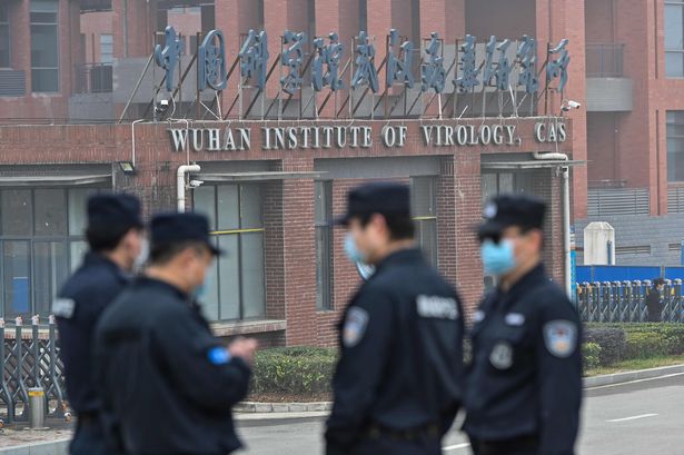 Security personnel stand guard outside the Wuhan lab during a WHO investigation