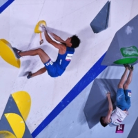 Tomoa Narasaki and Kazakhstan's Rishat Khaibullin compete on the bouldering wall on Tuesday. | REUTERS