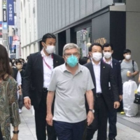 The man believed to be International Olympic Committee President Thomas Bach was seen walking in Tokyo's Ginza district on Monday. | COURTESY OF A PASSER-BY / VIA KYODO