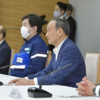 Prime Minister Yoshihide Suga speaks at a meeting of ministers Friday. | KYODO