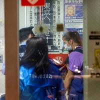 Belarusian athlete Krystsina Tsimanouskaya inside a police box at Haneda Airport in Tokyo on Sunday | REUTERS