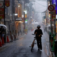 People walk on a shopping street in Osaka on Tuesday. | AFP-JIJI