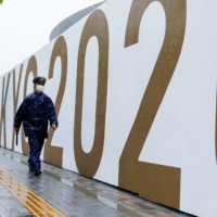 A policeman walks in front of the National Stadium in Tokyo on Monday, a day after the 2020 Olympics concluded. | REUTERS