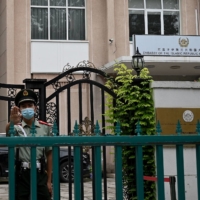 A Chinese paramilitary police stands guard outside the Afghanistan Embassy in Beijing on Monday. | AFP-JIJI