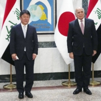 Foreign Minister Toshimitsu Motegi with Iraq's top envoy, Fuad Hussein, on Saturday in Baghdad.  | FOREIGN MINISTRY / VIA KYODO