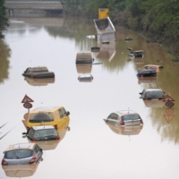 Submerged cars and other vehicles are seen on a federal highway in Erftstadt, western Germany, on July 17. | AFP-JIJI