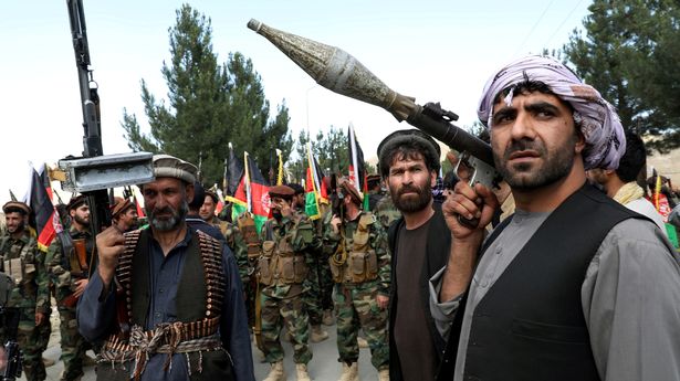 Armed men attend a gathering to announce their support for Afghan security forces in the fight against the Taliban, on the outskirts of Kabul, Afghanistan