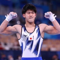 Daiki Hashimoto of Japan reacts after his routine on the horizontal bar on Tuesday at Ariake Gymnastics Center in Tokyo.  | REUTERS