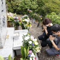 Members of bereaved families on Thursday commemorate the 36th anniversary of the Japan Airlines jet crash that claimed the lives of 520 people, at the crash site on Osutaka Ridge in Gunma Prefecture. | KYODO