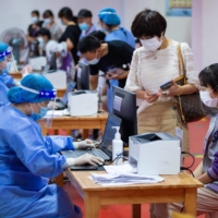 A high school student prepares to receive the Sinovac COVID-19 vaccine in Nanjing, China, on Aug. 21. | AFP-JIJI