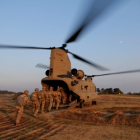 Members of South Korea and U.S. special forces get on a CH-47 Chinook helicopter during a joint military exercise in Gangwon province, South Korea, in November 2019.  | U.S. AIR FORCE / VIA REUTERS