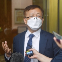 A plaintiffs' lawyer in a case filed by a group of South Koreans who were punished as World War II criminals after serving in the Imperial Japanese Army speaks to reporters at South Korea's Constitutional Court in Seoul on Tuesday. | KYODO